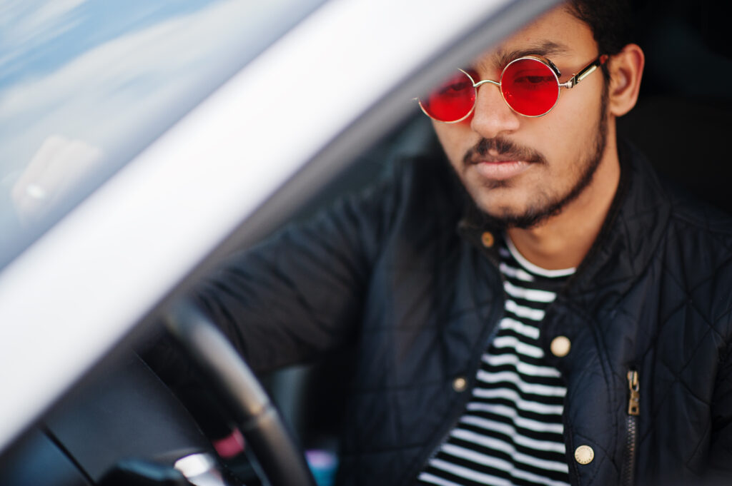 Man wearing transition lenses while driving in daylight